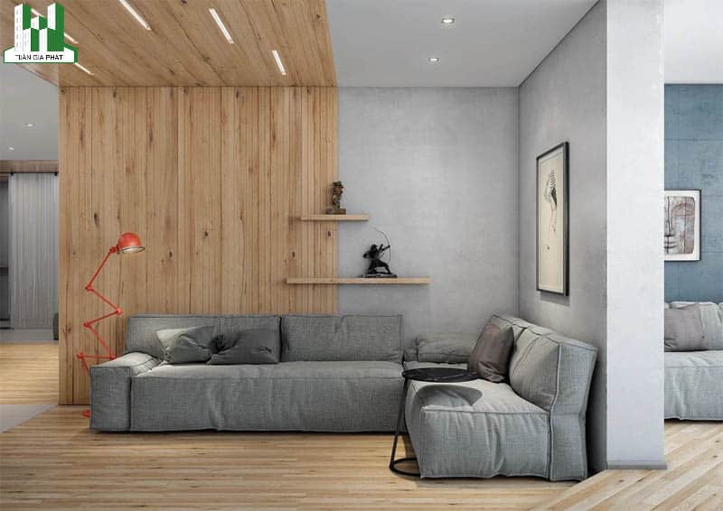 Màu xám kết hợp họa tiết bằng gỗ giúp cho căn phòng khách của bạn ấm áp hơn phải không. Bạn có thể sử dụng thêm chiếc đèn chiếu sáng với thiết kế khác biệt một chút để tô điểm cho ngôi nhà của mình.