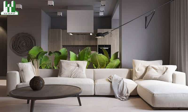 Sử dụng màu trắng, màu xám và màu xanh trong nội thất phòng khách hiện đại. Bức tường màu xám làm nền cho bức ảnh xoáy màu than, một chiếc đèn treo lơ lừng và không gian màu xanh phía sau của bộ sofa nâng tầm thẩm mỹ cho căn phòng này rất nhiều đó.